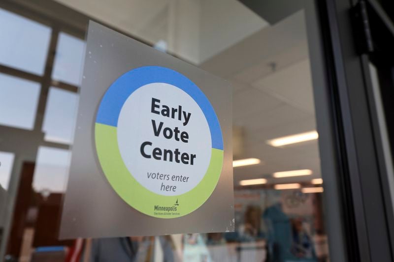 A sign welcoming voters on the door of the City of Minneapolis early voting center, Thursday, Sept. 19, 2024, in St. Paul, Minn. In-person voting in the 2024 presidential contest begins Friday in three states, including Democratic vice presidential candidate Tim Walz's home state of Minnesota, with just over six weeks left before Election Day. (AP Photo/Adam Bettcher)(AP Photo/Adam Bettcher)