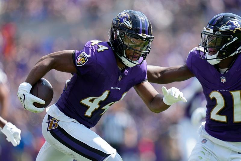 Baltimore Ravens cornerback Marlon Humphrey (44) runs with the ball after making an interception against the Las Vegas Raiders during the first half of an NFL football game, Sunday, Sept. 15, 2024, in Baltimore. (AP Photo/Stephanie Scarbrough)