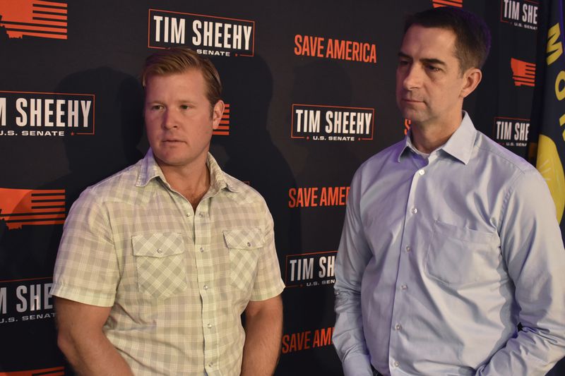 Montana Republican U.S. Senate candidate Tim Sheehy, left, and U.S. Sen. Tom Cotton, R-Ark., listen to a supporter at a campaign event at the Northern Hotel, Wednesday, Sept. 4, 2024, in Billings, Mont. (AP Photo/Matthew Brown)