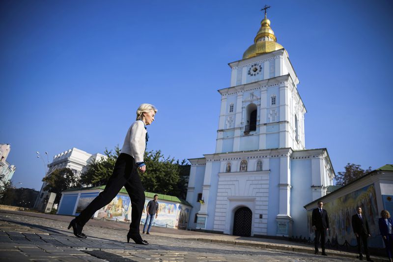 President of the European Commission Ursula von der Leyen, left, walks past St. Michael's Monastery on her way to visit a memorial wall commemorating the fallen Ukrainian soldiers in the war with Russia, in Kyiv, Ukraine, Friday, Sept. 20, 2024. (Christoph Soeder, Pool via AP)