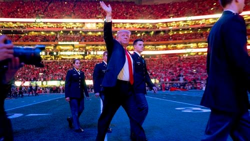 Then-President Donald Trump walks off the field before the start of the NCAA National Championship game between Alabama and Georgia in Atlanta in 2018.