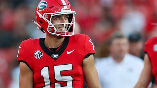 Georgia quarterback Carson Beck (15) talks with teammates as he prepares for their game against UAB at Sanford Stadium, Saturday, September 23, 2023, in Athens, Ga. (Jason Getz / Jason.Getz@ajc.com)