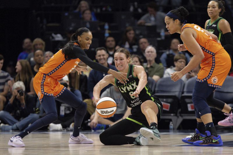 Minnesota Lynx forward Alanna Smith (8) tries to pass the ball away from Connecticut Sun forward DeWanna Bonner (24) during the second half of Game 1 of a WNBA basketball semifinals series Sunday, Sept. 29, 2024, in Minneapolis. (AP Photo/Stacy Bengs)