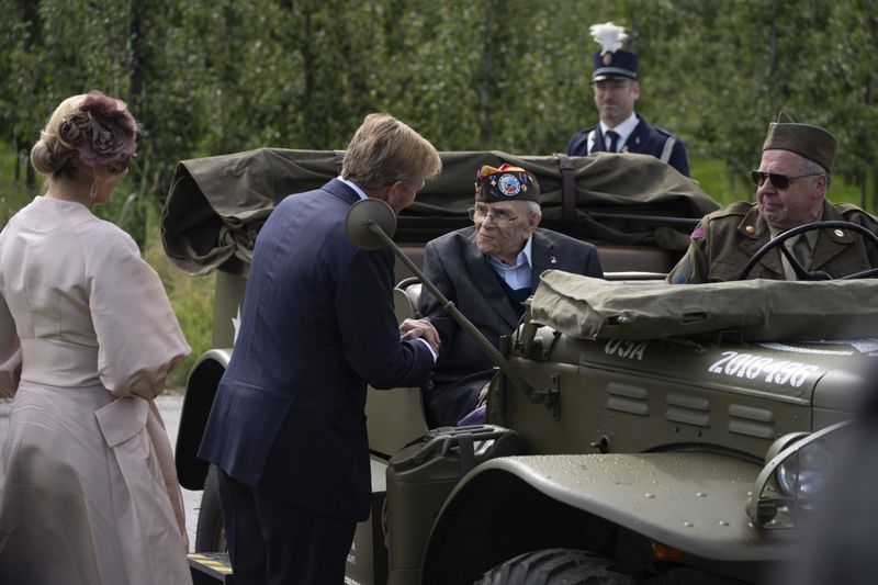 World War II veteran Kenneth Thayer is greeted by Dutch King Willem-Alexander and Queen Maxima before the royals joined Thayer in the jeep during a ceremony marking the 80th anniversary of the liberation of the south of the Netherlands in Mesch, Thursday, Sept. 12, 2024. (AP Photo/Peter Dejong, Pool)