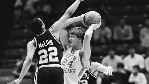 North Carolina's Joe Wolf (24) is stopped by Villanova players Gary McLain (22) and Harold Jensen (32) during early action at NCAA Southeast Regional finals at Birmingham, Ala., March 24, 1985. (AP Photo/File)