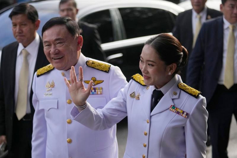 Thailand's former Prime Minister Thaksin Shinawatra, left and his daughter nad newly elected Prime Minister Paetongtarn Shinawatra arrive before the royal endorsement ceremony appointing Paetongtarn as Thailand's new prime minister at Pheu Thai party headquarters in Bangkok, Thailand, Sunday, Aug. 18, 2024. (AP Photo/Sakchai Lalit)