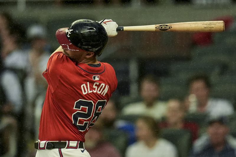 Atlanta Braves' Matt Olson (28) hits an RBI-double against the Los Angeles Dodgers inning of a baseball game, Friday, Sept. 13, 2024, in Atlanta. (AP Photo/Mike Stewart)