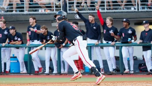UGA third baseman Charlie Condon (24) watches the ball after hitting an RBI single during the fifth inning against Ga Tech during the NCAA Tournament Regional at Foley Field on Sunday, June 2, 2024, in Athens.  (Miguel Martinez / AJC)
