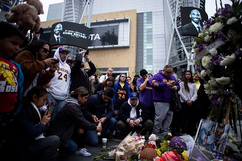Mourners gather at a makeshift memorial Sunday for Kobe Bryant, the retired Los Angeles Lakers star, outside of the Staples Center in Los Angeles.