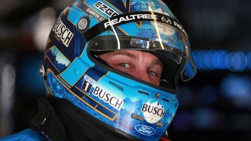 In his garage at Atlanta Motor Speedway, Kevin Harvick flashes a knowing look from beneath his racing armor. (Photo by Sean Gardner/Getty Images)