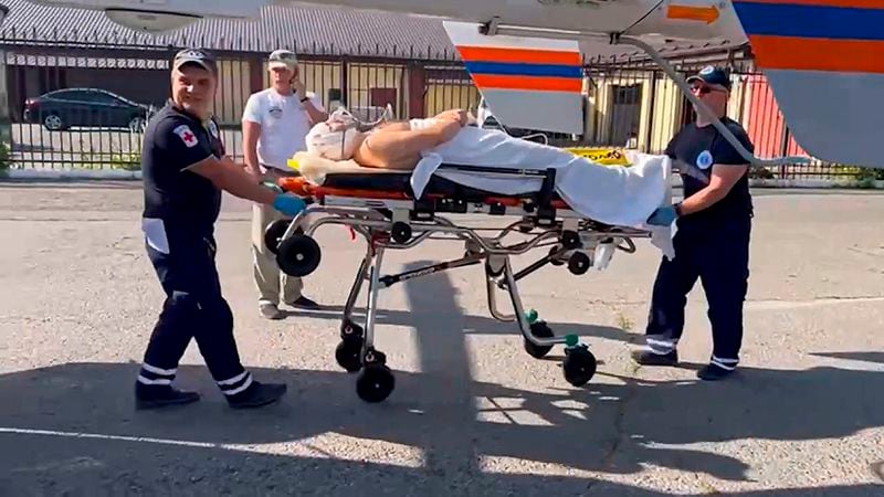 In this photo taken from video released by Moscow Region Governor Andrei Vorobyev official telegram channel, medical workers roll on a stretcher with a wounded man to a helicopter and transfer him to a Moscow's hospital, after an alleged Ukrainian drone attack on multi-storey residential building in Ramenskoye, outside Moscow, Moscow region, Russia, on Tuesday, Sept. 10, 2024. (Moscow Region Governor Andrei Vorobyev official telegram channel via AP)