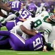 New York Jets quarterback Aaron Rodgers (8), right, reacts as he is tackled during the second half of an NFL football game against the Minnesota Vikings, Sunday, Oct. 6, 2024, at the Tottenham Hotspur stadium in London. (AP Photo/Kirsty Wigglesworth)