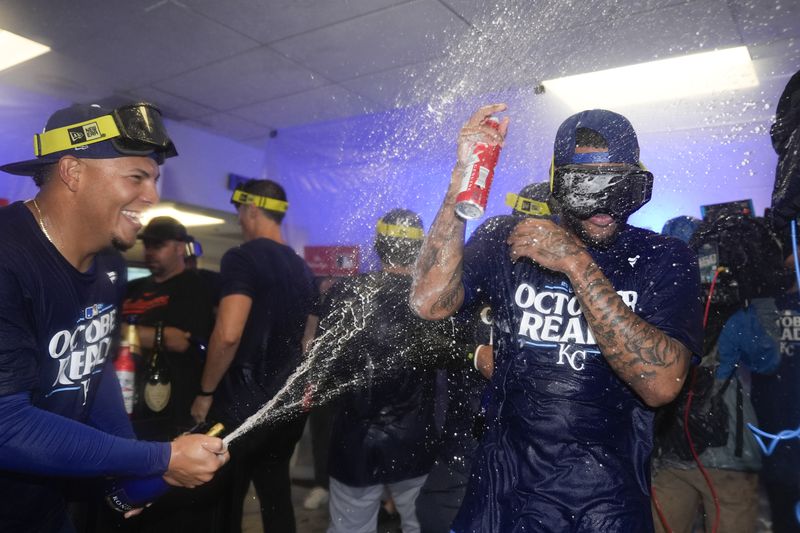 Kansas City Royals pitcher Angel Zerpa, left, douses third base Maikel Garcia as they celebrate with teammates after defeating the Baltimore Orioles 2-1 in Game 2 of an AL Wild Card Series baseball game, Wednesday, Oct. 2, 2024 in Baltimore. (AP Photo/Stephanie Scarbrough)