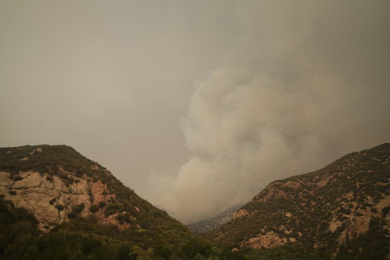 A plume of smoke from the Line Fire is seen Monday, Sept. 9, 2024, outside of Forest Falls, Calif. (AP Photo/Eric Thayer)