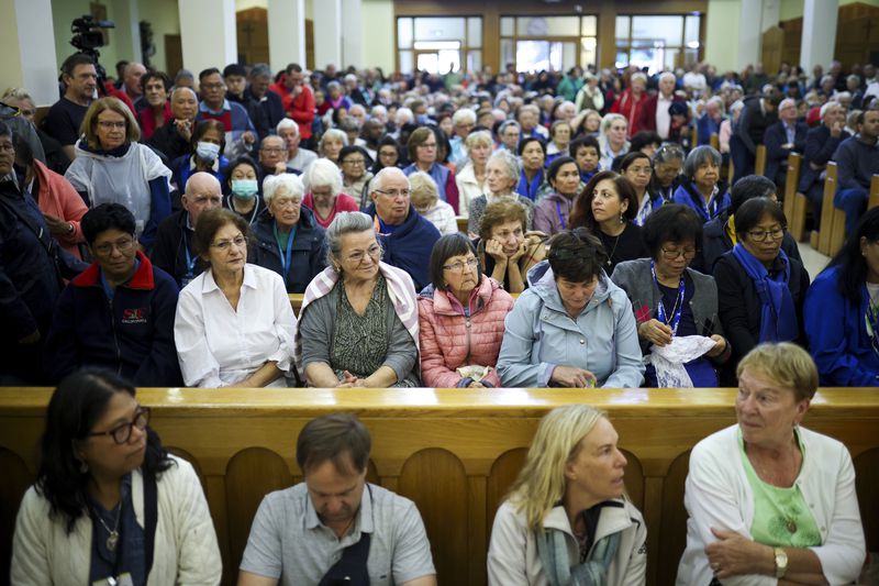 Pilgrims say their prayers inside the St. James Church in Medjugorje, Bosnia, Thursday, Sept. 19, 2024. (AP Photo/Armin Durgut)