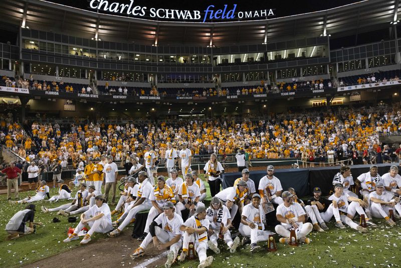 Tennessee team members watch a commemorative video of their time in the NCAA College World Series baseball finals following their victory over Texas A&M in Omaha, Neb., Monday, June 24, 2024. (AP Photo/Rebecca S. Gratz)