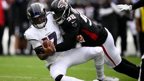 Baltimore Ravens quarterback Josh Johnson is sacked by Atlanta Falcons defensive tackle Ruke Orhorhoro during the first half of a preseason NFL football game on Saturday, Aug. 17, 2024, in Baltimore. (AP Photo/Nick Wass)