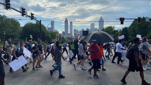 A group of peaceful demonstrators march down Boulevard on Thursday afternoon in Atlanta’s Old Fourth Ward neighborhood.