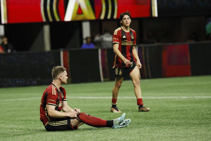 Atlanta United forward Jackson Conway sits on the ground as Luke Brennan walks off at the end of the game against Liga MX Toluca in an exhibition on Wednesday, Feb 15, 2023, in Atlanta. Toluca defeated Atlanta United 4-3.
 Miguel Martinez / miguel.martinezjimenez@ajc.com