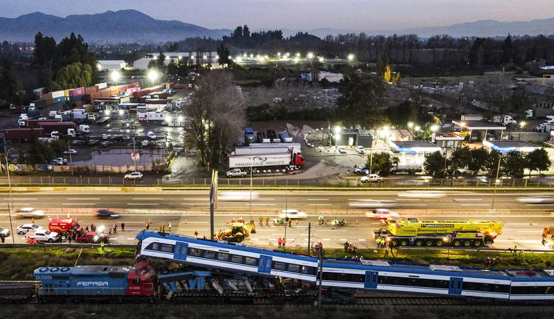 Police inspect two trains that collided in San Bernardo, Santiago, Chile, Thursday, June 20, 2024 (AP Photo/Esteban Felix)