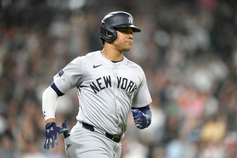 New York Yankees' Juan Soto, right, watches his home run off Chicago White Sox starting pitcher Jonathan Cannon, his second of the game, in the fifth inning of a baseball game Tuesday, Aug. 13, 2024, in Chicago. (AP Photo/Charles Rex Arbogast)