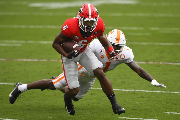 Georgia running back Kenny McIntosh (6) avoids the tackle of Tennessee defensive back Trevon Flowers during the second half of a football game Saturday, Oct. 10, 2020, at Sanford Stadium in Athens. Georgia won 44-21. JOHN AMIS FOR THE ATLANTA JOURNAL- CONSTITUTION