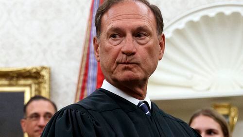 FILE - Supreme Court Justice Samuel Alito pauses after swearing in Mark Esper as Secretary of Defense during a ceremony with President Donald Trump in the Oval Office at the White House in Washington, July 23, 2019. A second flag of a type carried by rioters during the attack on the U.S. Capitol on Jan. 6, 2021, was displayed outside a house owned by Alito according to a report published May 22, 2024, by The New York Times. (AP Photo/Carolyn Kaster, File)