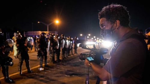 Ryon Horne, a photojournalist for the AJC records protestors and police on I-75 after the Rayshard Brooks shooting in 2020. The AJC announced the hiring of five new visual journalists. (Ben Grey for The Atlanta Journal-Constitution)