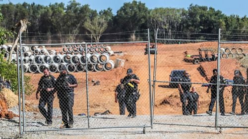 Protesters gathered on Constitution Road (shown here) after five individuals were arrested Thursday morning, Sept. 7, 2023, at the site of Atlanta's proposed public safety training center after chaining themselves to construction equipment in an effort to halt work. According to the Atlanta Police Department, the training center opponents broke into the construction site off Constitution Road around 9:30 a.m. Thursday. (John Spink/The Atlanta Journal-Constitution/TNS)