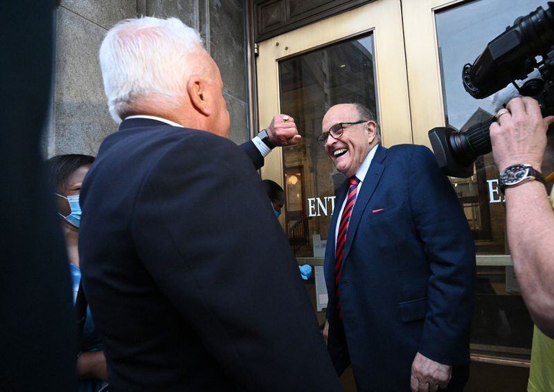 August 17, 2022 Atlanta - Rudy Giuliani smiles as he arrives with his attorney Robert J. Costello (left) to testify for the special grand jury at Fulton County Courthouse in Atlanta on Wednesday, August 17, 2022. (Hyosub Shin / Hyosub.Shin@ajc.com)