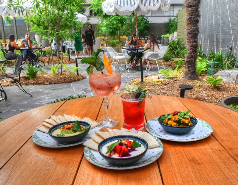 Among the offerings at Willow Bar at Kimpton Sylvan Hotel are, clockwise from top left: the Cyprus gin and tonic, Willow cocktail, charred cauliflower and cucumber avocado,  beets and feta, and hummus. Chris Hunt for The Atlanta Journal-Constitution 