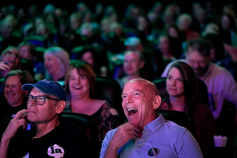 Chris Covert, front right, from Leawood, Kan., watches the presidential debate between Republican presidential nominee former President Donald Trump and Democratic presidential nominee Vice President Kamala Harris at a 97-year-old movie theater Tuesday, Sept. 10, 2024, in Shawnee, Kan. (AP Photo/Charlie Riedel)