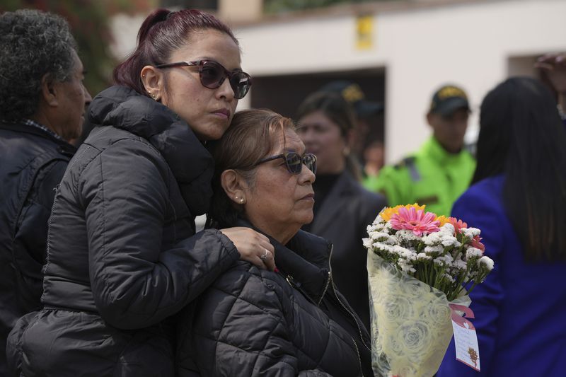 Supporters of former President Alberto Fujimori gather outside the home of his daughter Keiko, the day after he died in Lima, Peru, Thursday, Sept. 12, 2024. (AP Photo/Guadalupe Pardo)