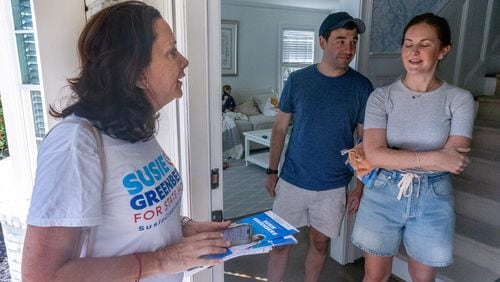 Democratic state House candidate Susie Greenberg, shown talking to homeowners Catherine and Brad Cohen as she canvasses a Sandy Springs neighborhood Saturday, said switching in Vice President Kamala Harris has boosted enthusiasm within the party. "The energy is palpable," she said. (Steve Schaefer / AJC)