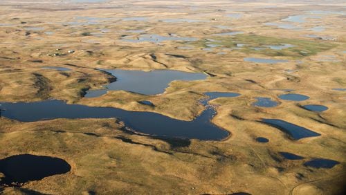 An aerial view shows shallow lakes and ponds in part of North America's vast Prairie Pothole Region. Cox Enterprises recently donated $100 million to Ducks Unlimited to support conservation in the areas.