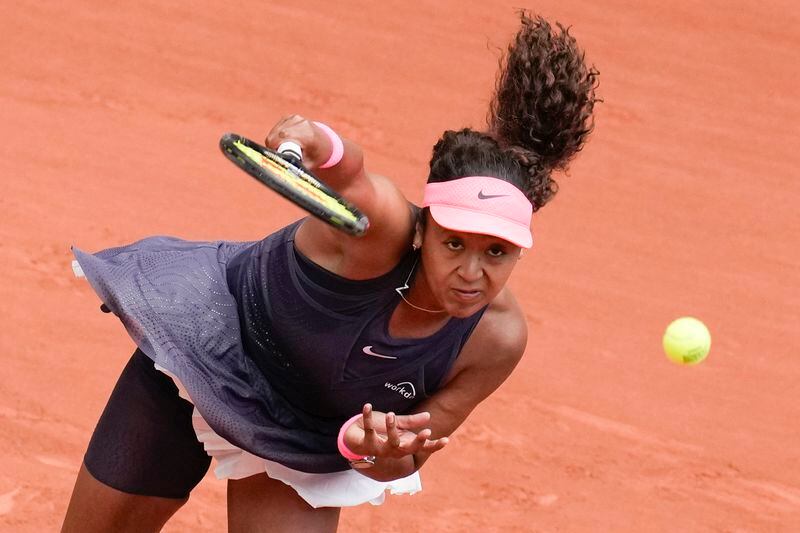 Japan's Naomi Osaka serves against Italy's Lucia Bronzetti during their first round match of the French Open tennis tournament at the Roland Garros stadium in Paris, Sunday, May 26, 2024. (AP Photo/Christophe Ena)