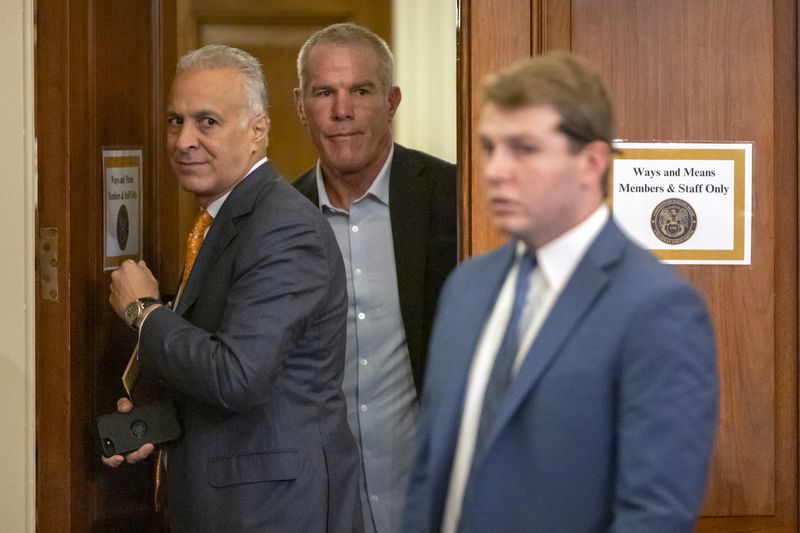 Former NFL quarterback Brett Favre, center, arrives to appear before the House Committee on Ways and Means on Capitol Hill, Tuesday, Sept. 24, 2024, in Washington. (AP Photo/Mark Schiefelbein)