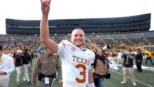 Texas quarterback Quinn Ewers smiles while acknowledging the crowd after an NCAA college football game against Michigan in Ann Arbor, Mich., Saturday, Sept. 7, 2024. (AP Photo/Paul Sancya)