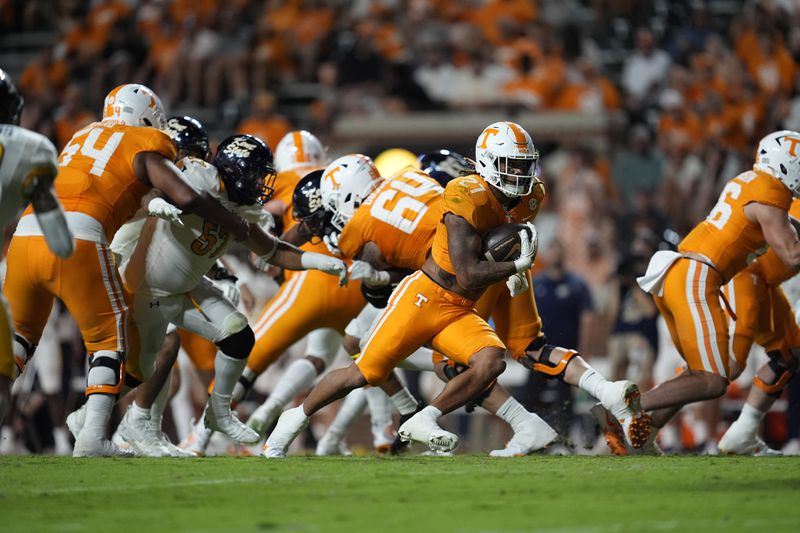 Tennessee running back Payton Lewis (27) runs the ball during the second half of an NCAA college football game against Kent State, Saturday, Sept. 14, 2024, in Knoxville, Tenn. (AP Photo/George Walker IV)