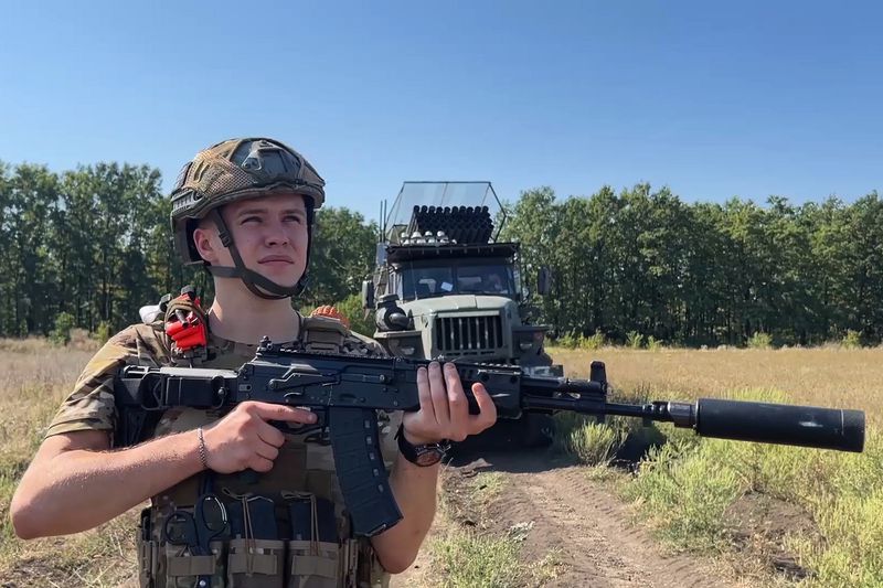 In this photo taken from a video released by the Russian Defense Ministry press service on Thursday, Sept. 26, 2024, Russian serviceman stands next to a BM-21 Grad self-propelled 122 mm multiple rocket launcher being prepared to operate on an undisclosed location in Ukraine. (Russian Defense Ministry Press Service via AP)