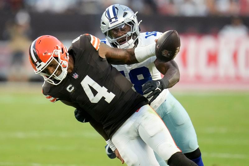 Cleveland Browns quarterback Deshaun Watson (4) runs for a gain before being tackled by Dallas Cowboys linebacker Damone Clark (18) in the second half of an NFL football game in Cleveland, Sunday, Sept. 8, 2024. (AP Photo/Sue Ogrocki)