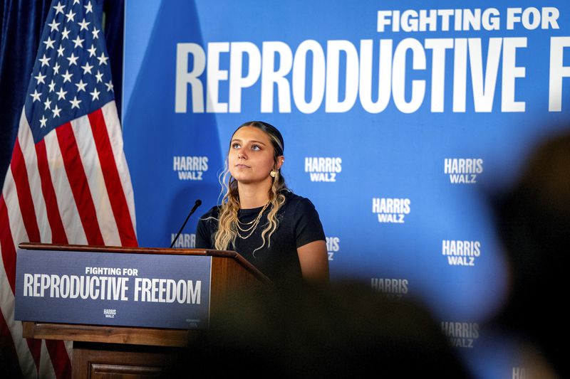 Hadley Duvall, a sexual assault survivor and reproductive rights advocate who spoke at the Democratic National Convention, joins a rally for Vice President Harris at the Independence Visitor Center in Philadelphia, Sunday, Sept. 15, 2024. Gov. Josh Shapiro headlined the reproductive rights rally before the campaign's national "Fighting for Reproductive Freedom" bus departed on a tour across Pennsylvania. (Tom Gralish/The Philadelphia Inquirer via AP)