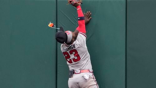 Braves center fielder Michael Harris II (23) loses his glasses as he hits the outfield wall catching a fly ball by St. Louis Cardinals' Paul Goldschmidt to end the eighth inning of a baseball game Wednesday, April 5, 2023, in St. Louis. (AP Photo/Jeff Roberson)