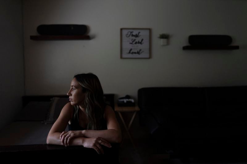 Mikayla Brown sits for a photo in the room of her son, Elijah, who died of a fentanyl overdose at 15, in Atascadero, Calif., Friday, Aug. 2, 2024, as two of his skateboards hang on the wall. (AP Photo/Jae C. Hong)