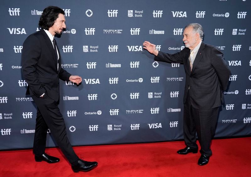 Francis Ford Coppola, right, the writer/director of "Megalopolis," greets cast member Adam Driver at the North American premiere of the film at Roy Thomson Hall during the Toronto International Film Festival, Monday, Sept. 9, 2024, in Toronto. (AP Photo/Chris Pizzello)