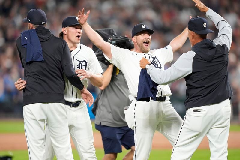 Members of the Detroit Tigers celebrate after the ninth inning of a baseball game against the Chicago White Sox, Friday, Sept. 27, 2024, in Detroit. (AP Photo/Carlos Osorio)