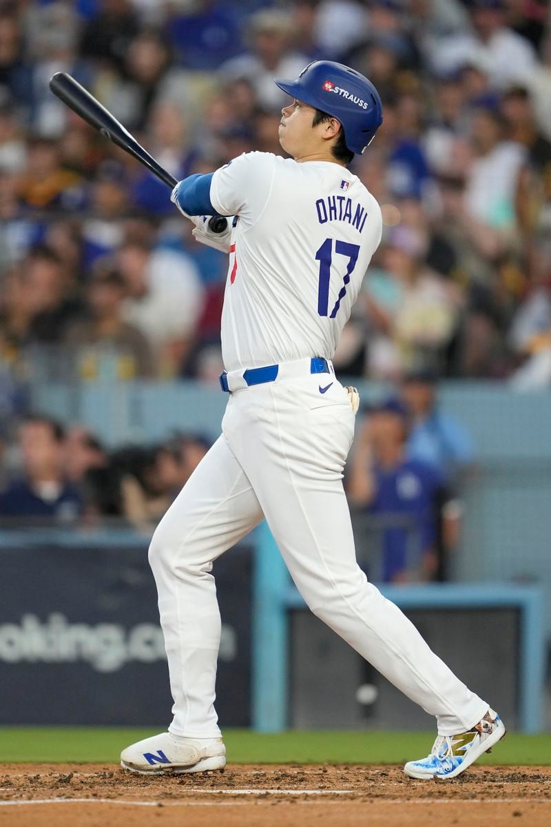 Los Angeles Dodgers' Shohei Ohtani watches his three-run home run during the second inning in Game 1 of baseball's NL Division Series against the San Diego Padres, Saturday, Oct. 5, 2024, in Los Angeles. (AP Photo/Ashley Landis)