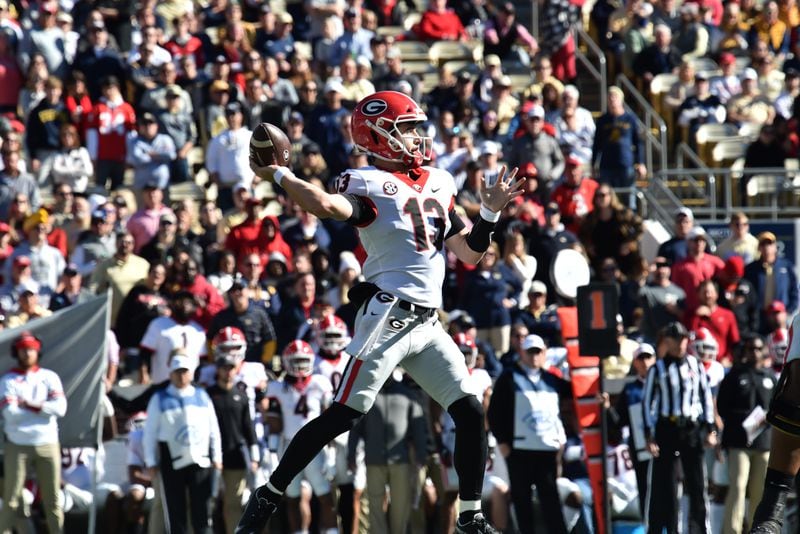 Georgia's quarterback Stetson Bennett (13) gets off a pass during the first half of an NCAA college football game at Georgia Tech's Bobby Dodd Stadium in Atlanta on Saturday, November 27, 2021. (Hyosub Shin / Hyosub.Shin@ajc.com)