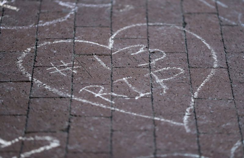 Columbus Blue Jackets fans leave chalk messages during the candlelight vigil to honor Blue Jackets hockey player Johnny Gaudreau, Thursday, Sept. 4, 2024, outside of Nationwide Arena in Columbus, Ohio. Gaudreau and his brother Matthew were killed by a motor vehicle last week while riding bicycles. (AP Photo/Joe Maiorana)