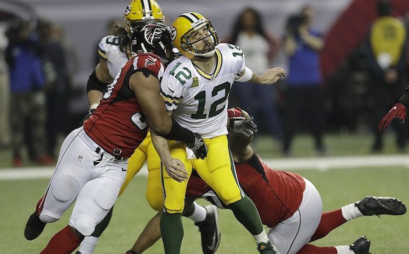 Atlanta Falcons defensive end Dwight Freeney (93) hits Green Bay Packers' Aaron Rodgers after he throws during the second half of the NFL football NFC championship game Sunday, Jan. 22, 2017, in Atlanta. (AP Photo/David J. Phillip)